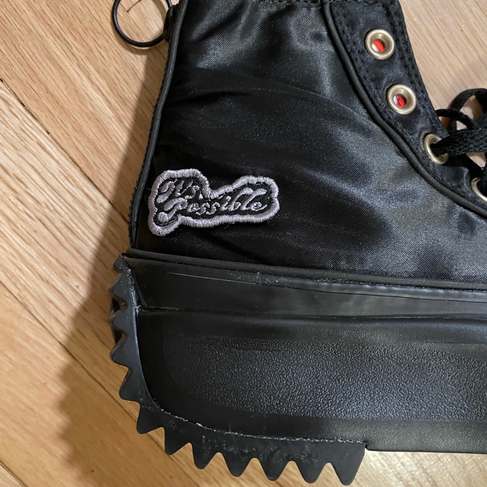 Women’s black on black It’s Possible platforms.